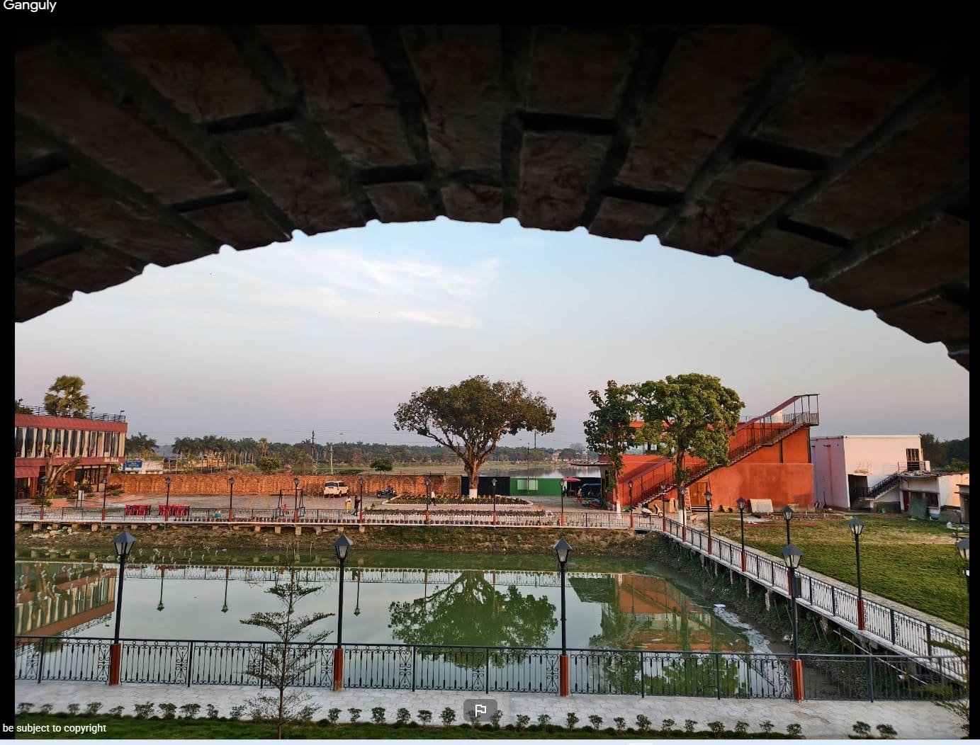 The view out over the water and lawns, framed by one of the resort's brick arches