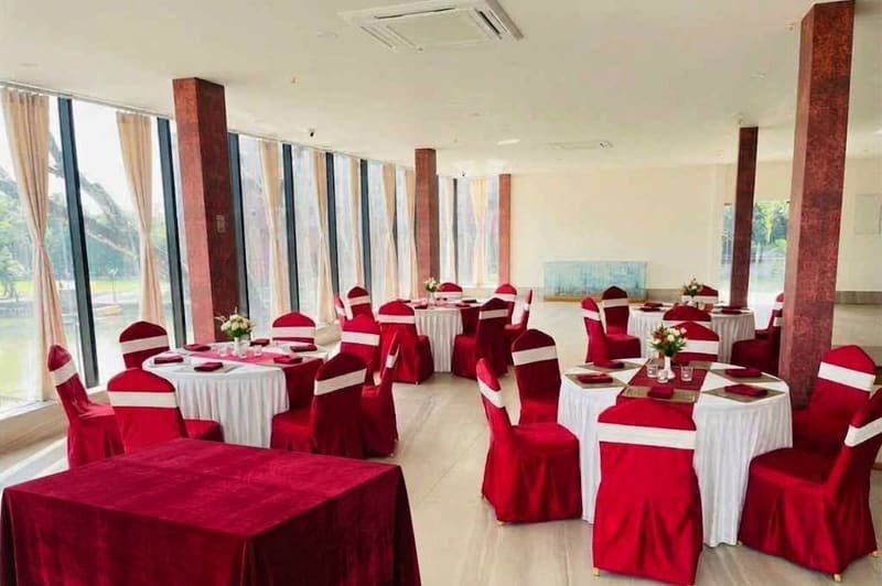 Round banquet tables in red and gold ready for a reception