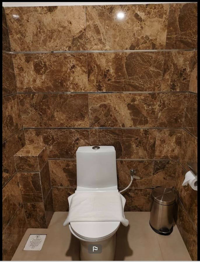 A washroom with fittings against marble tiling