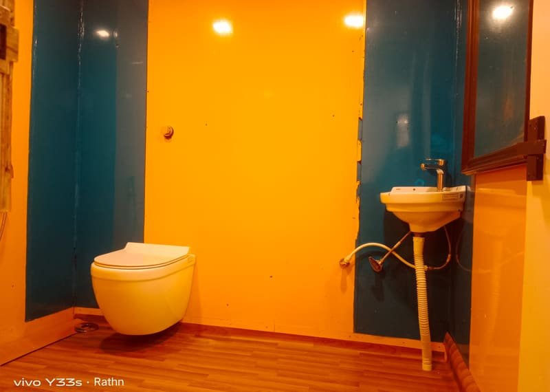 A washbasin against a painted wall in a boat house