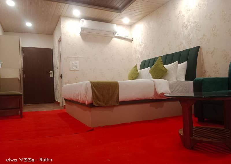 A boat house with twin beds and a green sofa