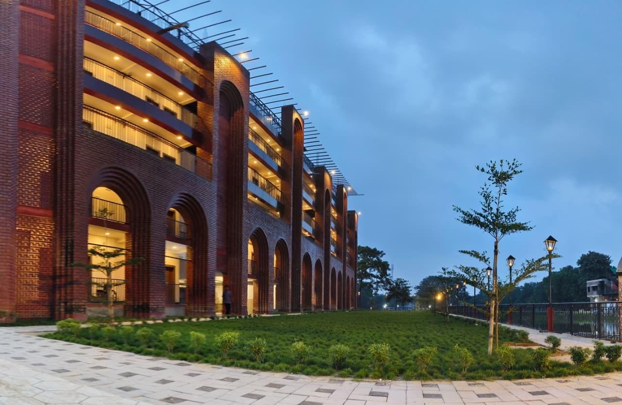 The resort's brick arcade at dusk, its lawns running alongside