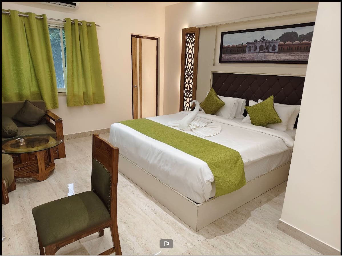 Deluxe room with a double bed and framed print