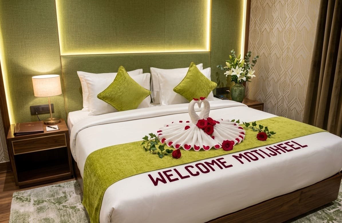 A suite bed dressed with flowers and a folded swan