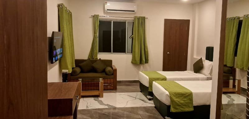 Super deluxe room with two beds and a seating corner
